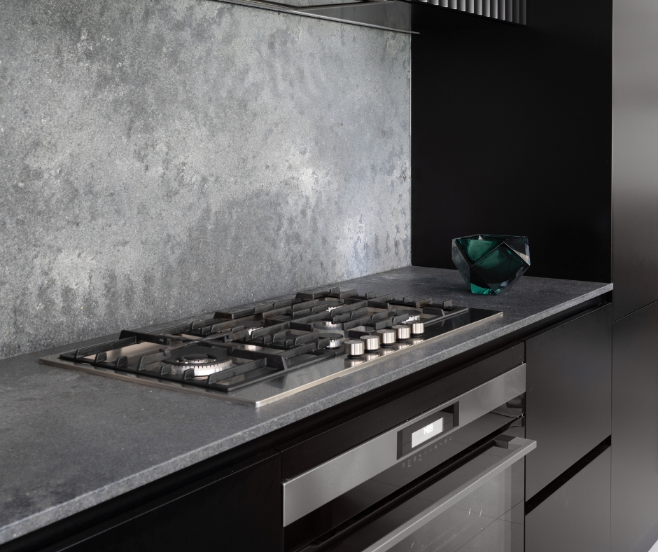 Monochrome Kitchen, with stone splashback and Black appliances, as well as black custom cabinetry